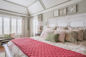 cream bedroom with pink accent blanket