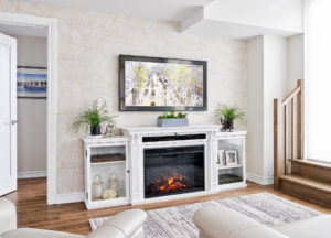 painting above white fireplace mantel in living room